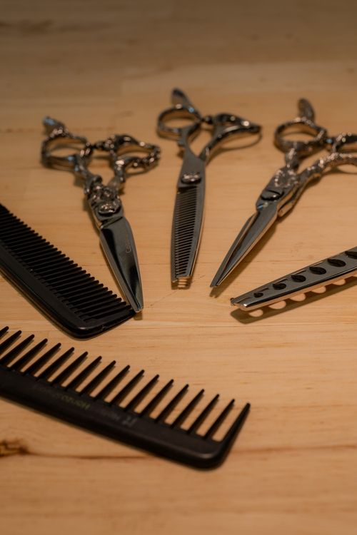 A person cutting woman's hair