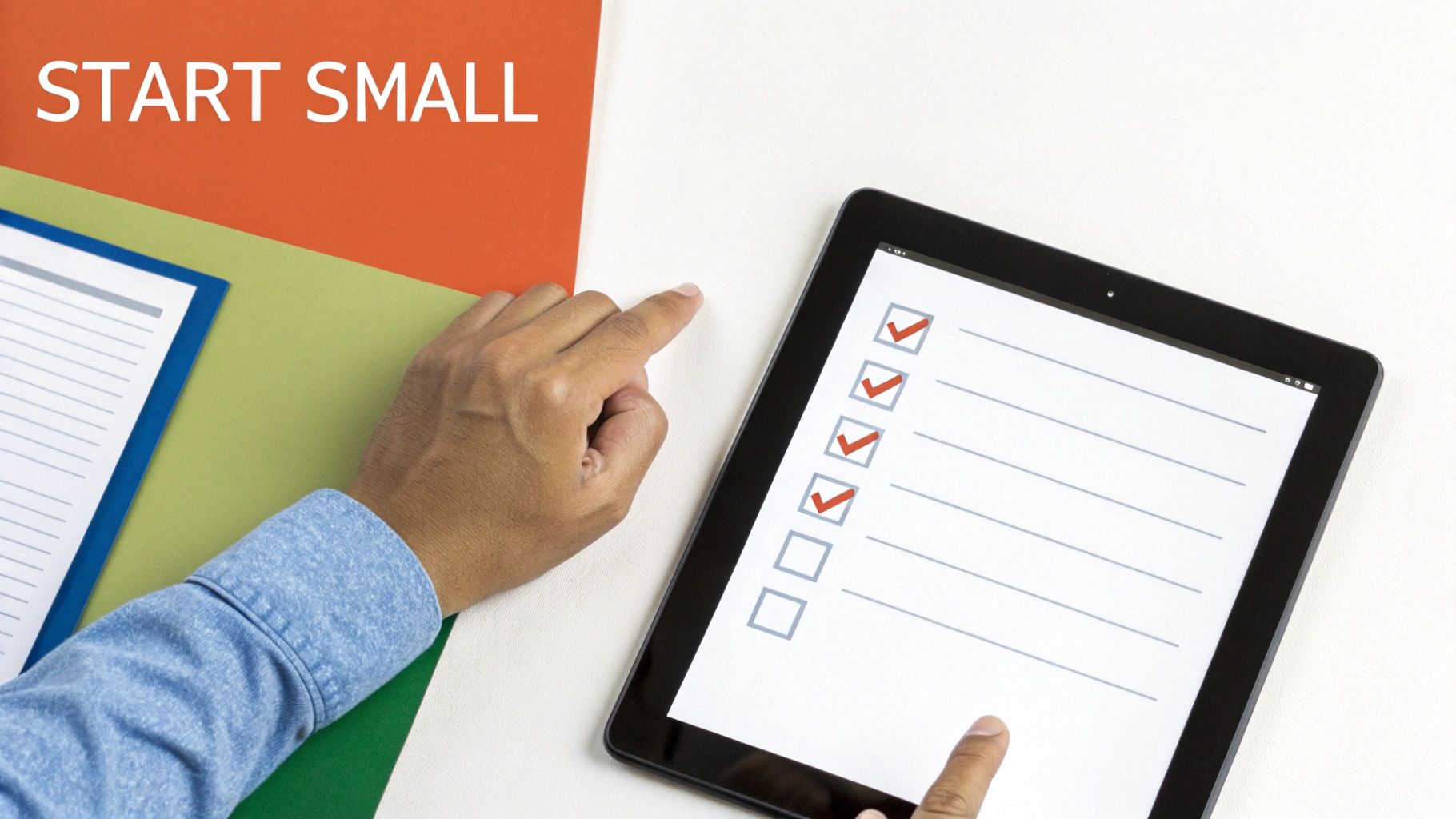 Hands interacting with a tablet showing a partially completed checklist, next to a 'START SMALL' sign.