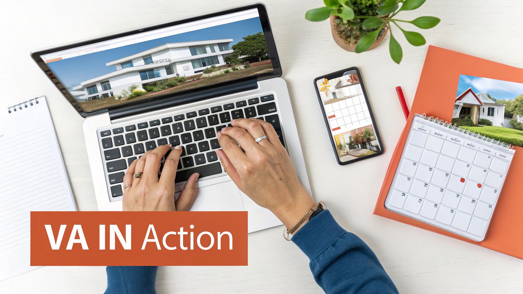 Overhead view of hands typing on a laptop displaying a house, with a phone and calendar nearby.