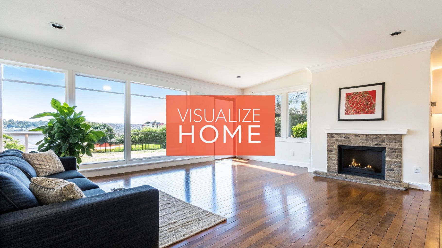 A bright and spacious living room with large windows, hardwood floors, a sofa, and a stone fireplace.