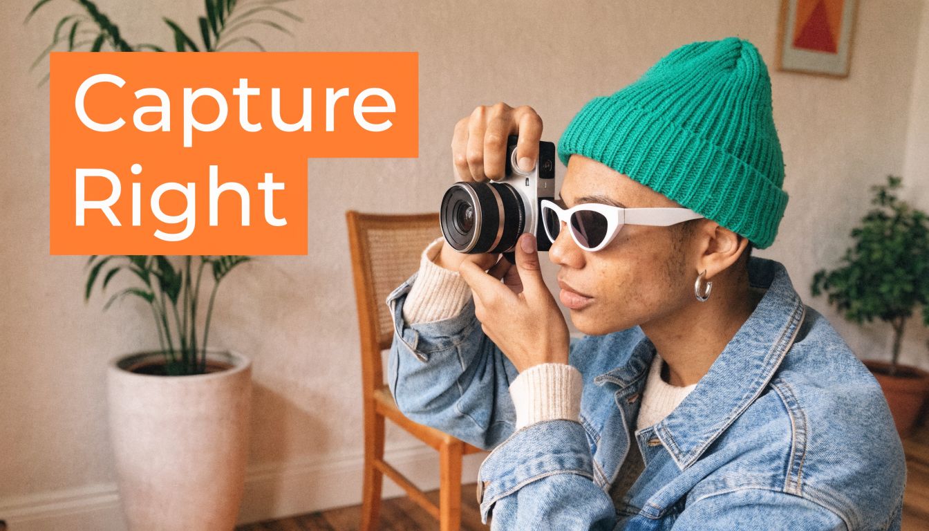 A stylish young photographer wearing a green beanie and white sunglasses using a camera indoors.