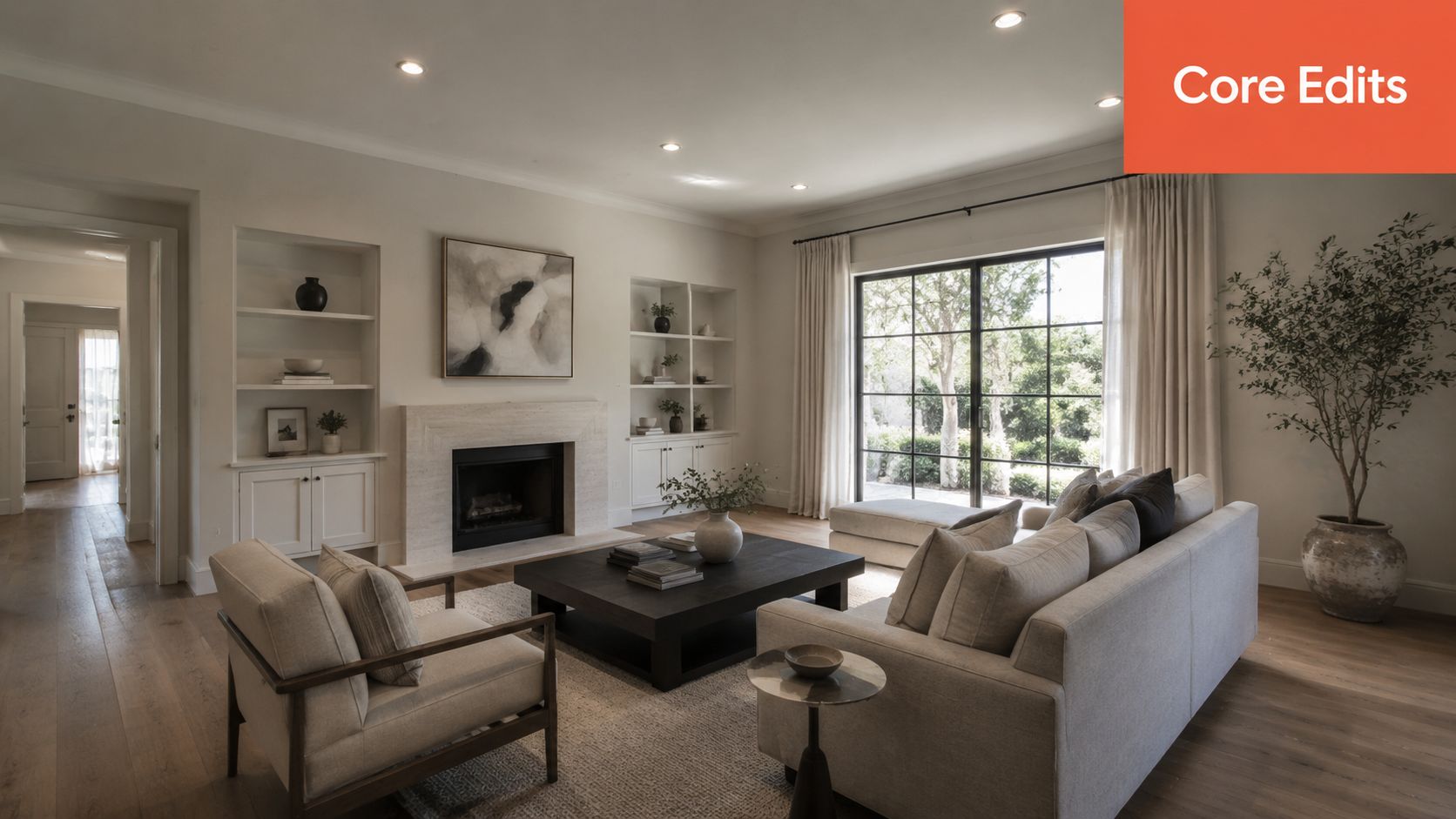 A modern, bright, and elegantly decorated living room featuring comfortable seating, a fireplace, and large glass doors.
