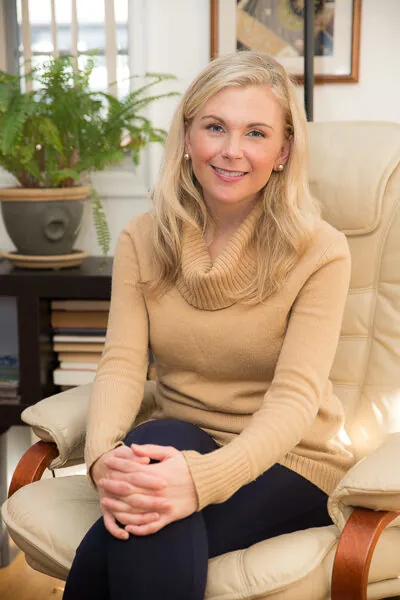 Tanya Schoettler, LPCC sitting in a chair ready for a session.