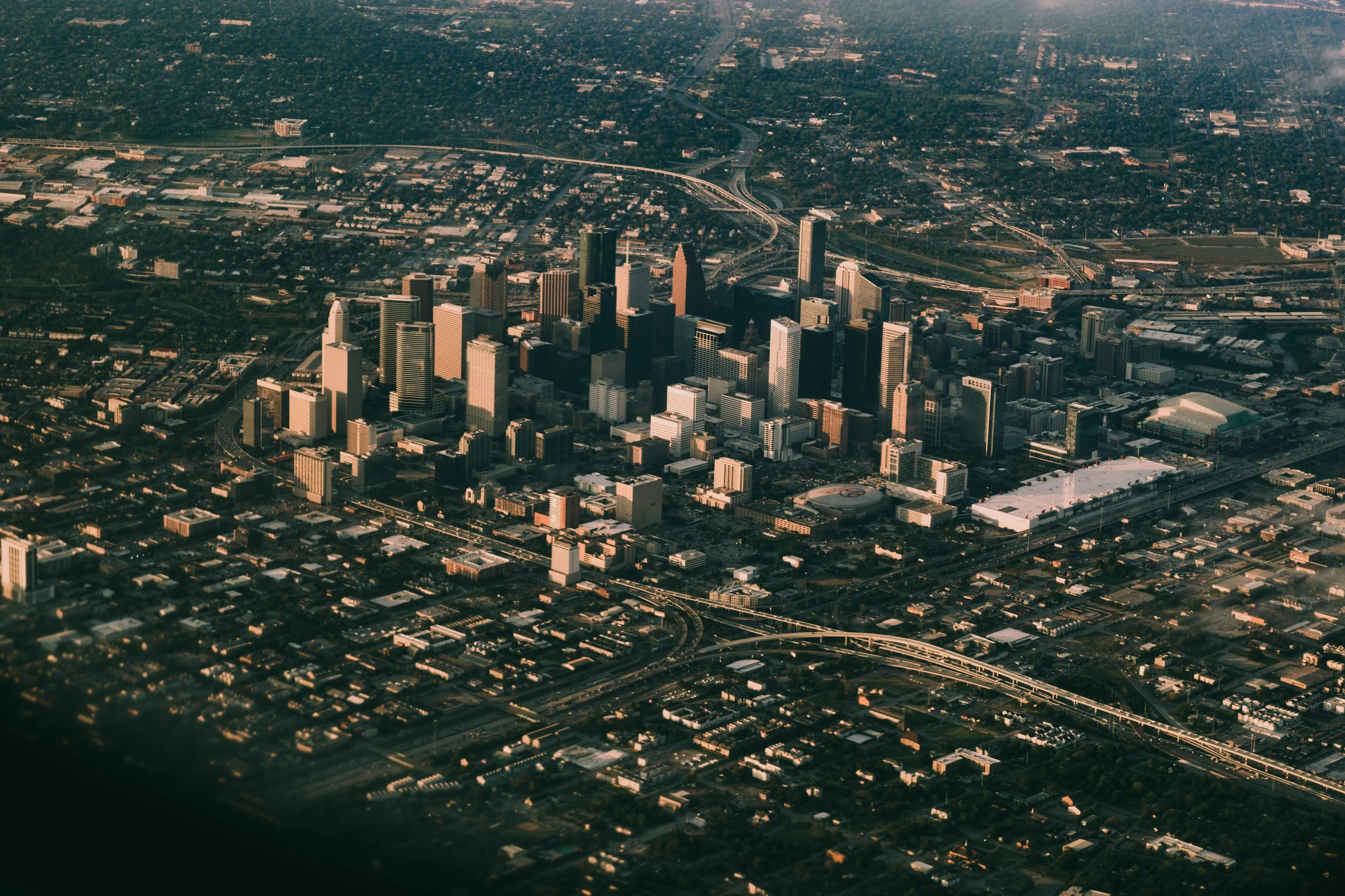 This shows downtown Houston from a unique birds eye view––potentially from a helicopter or airplane.