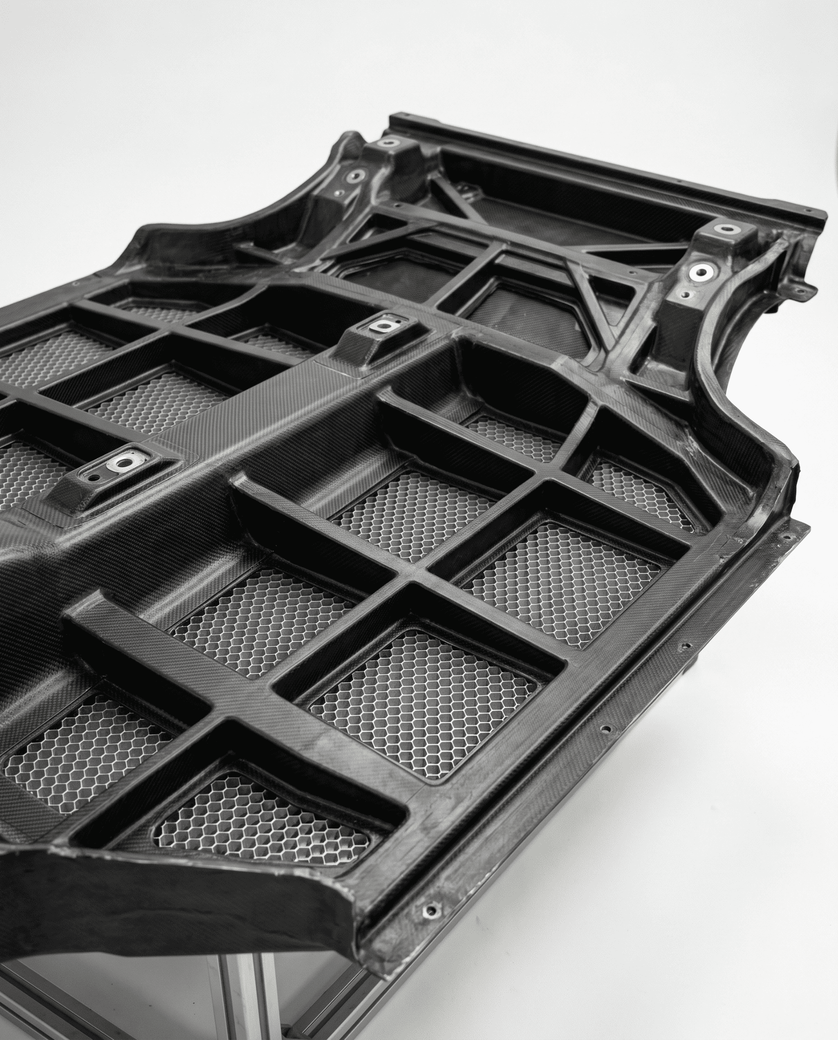 CFRP rear floor module with integrated ribs and honeycomb core