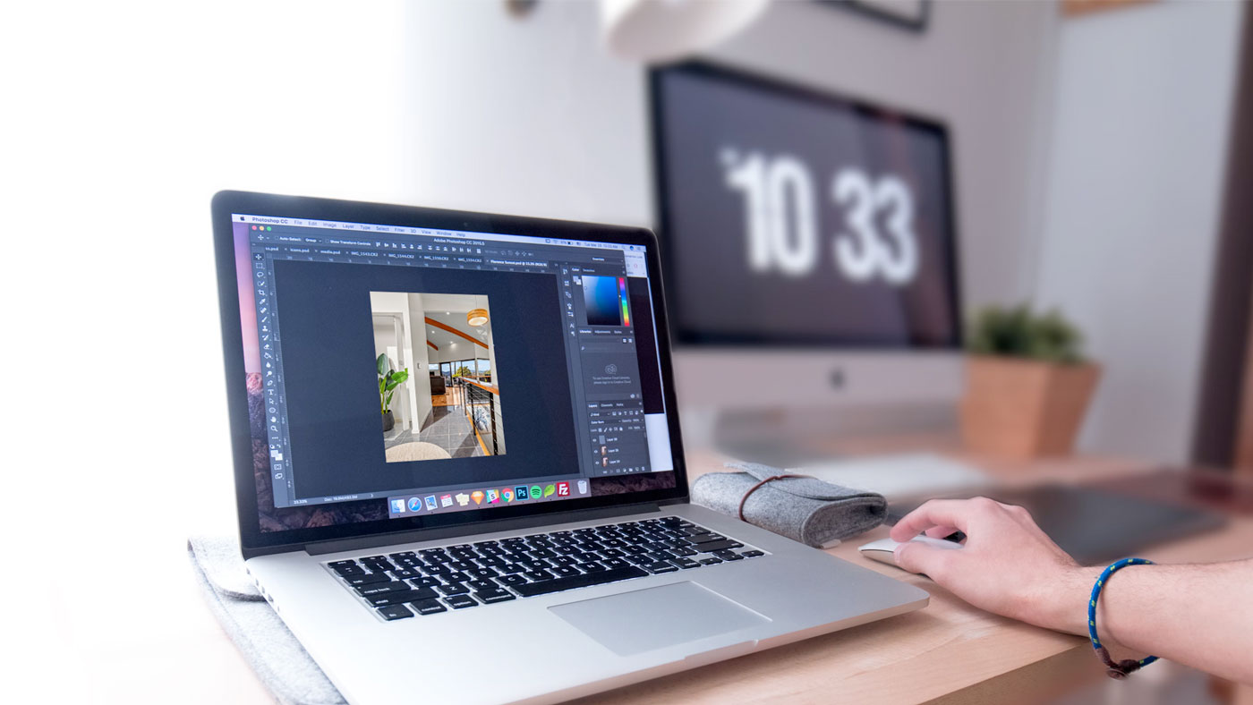 person using computer with property photo open