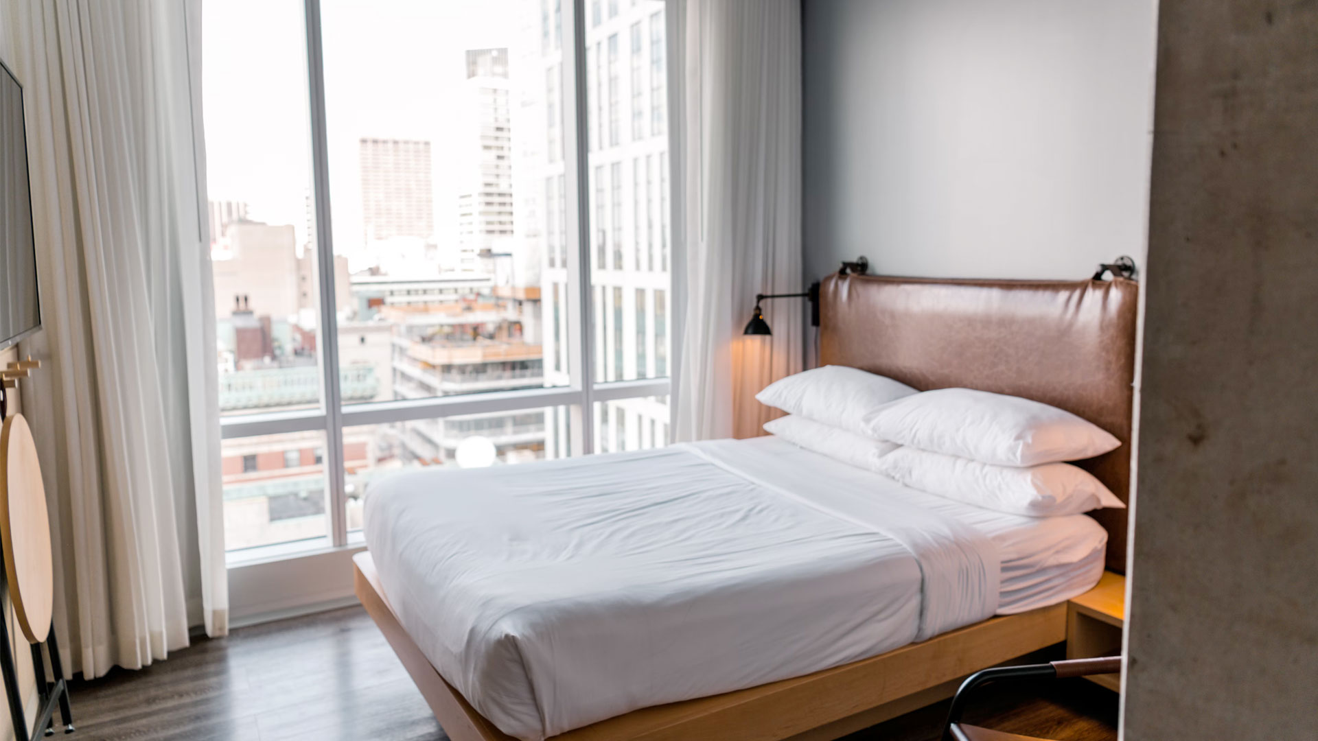 interior shot of bed in room with bright exeterior