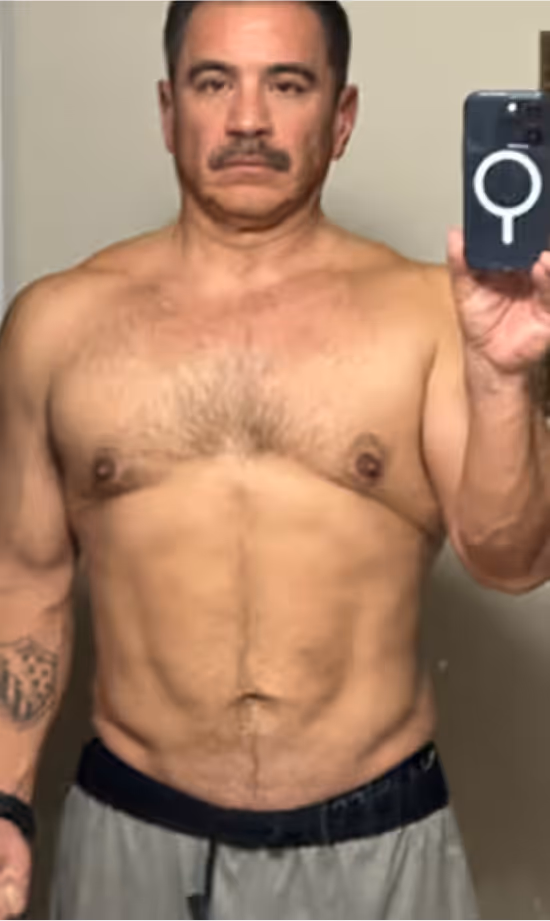 Man posing proudly in front of mirror