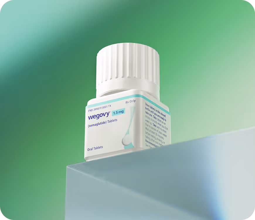 A white bottle of Wegovy 1.5 mg (semaglutide) oral tablets on a green background.
