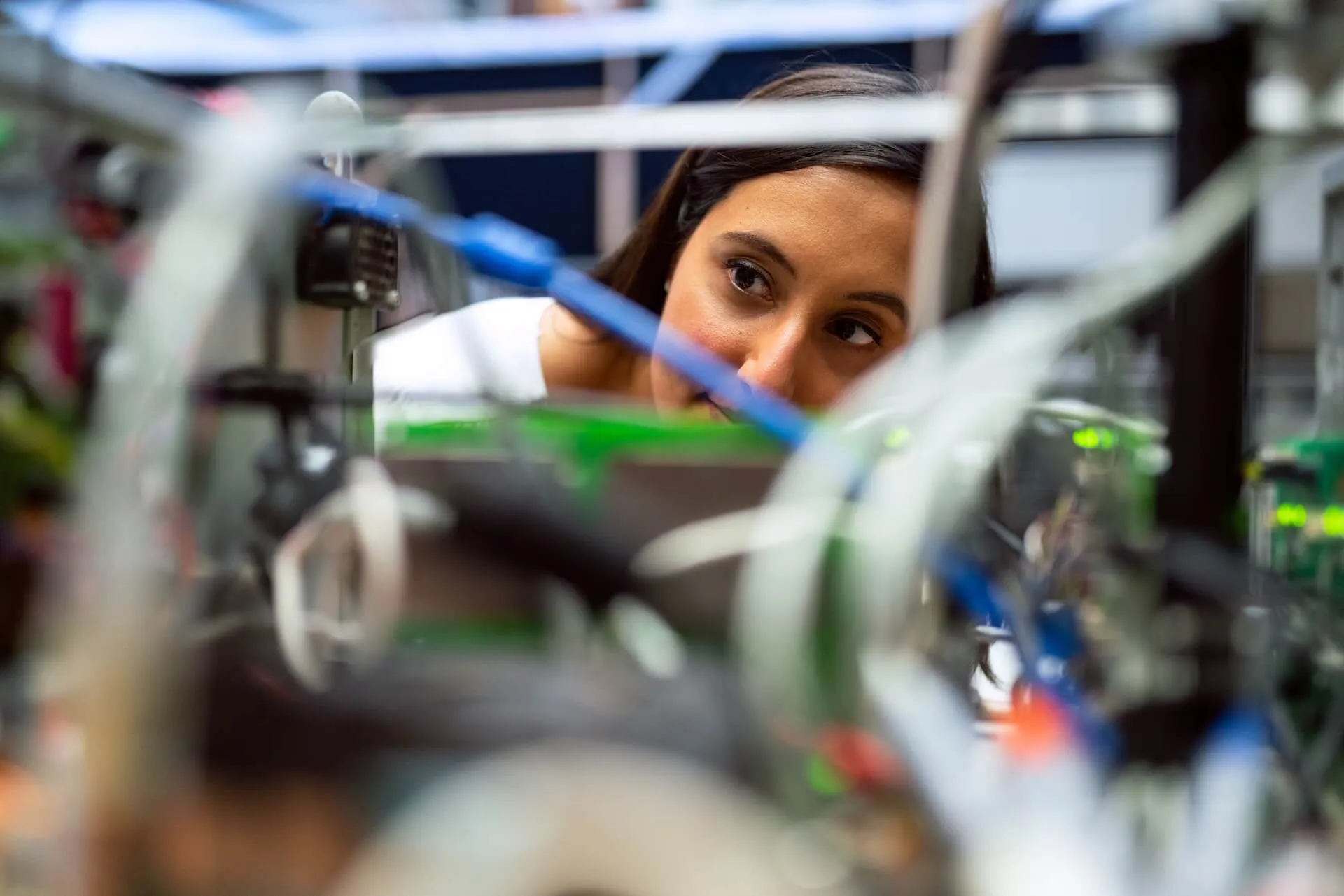 A woman looking at a machine in a factory