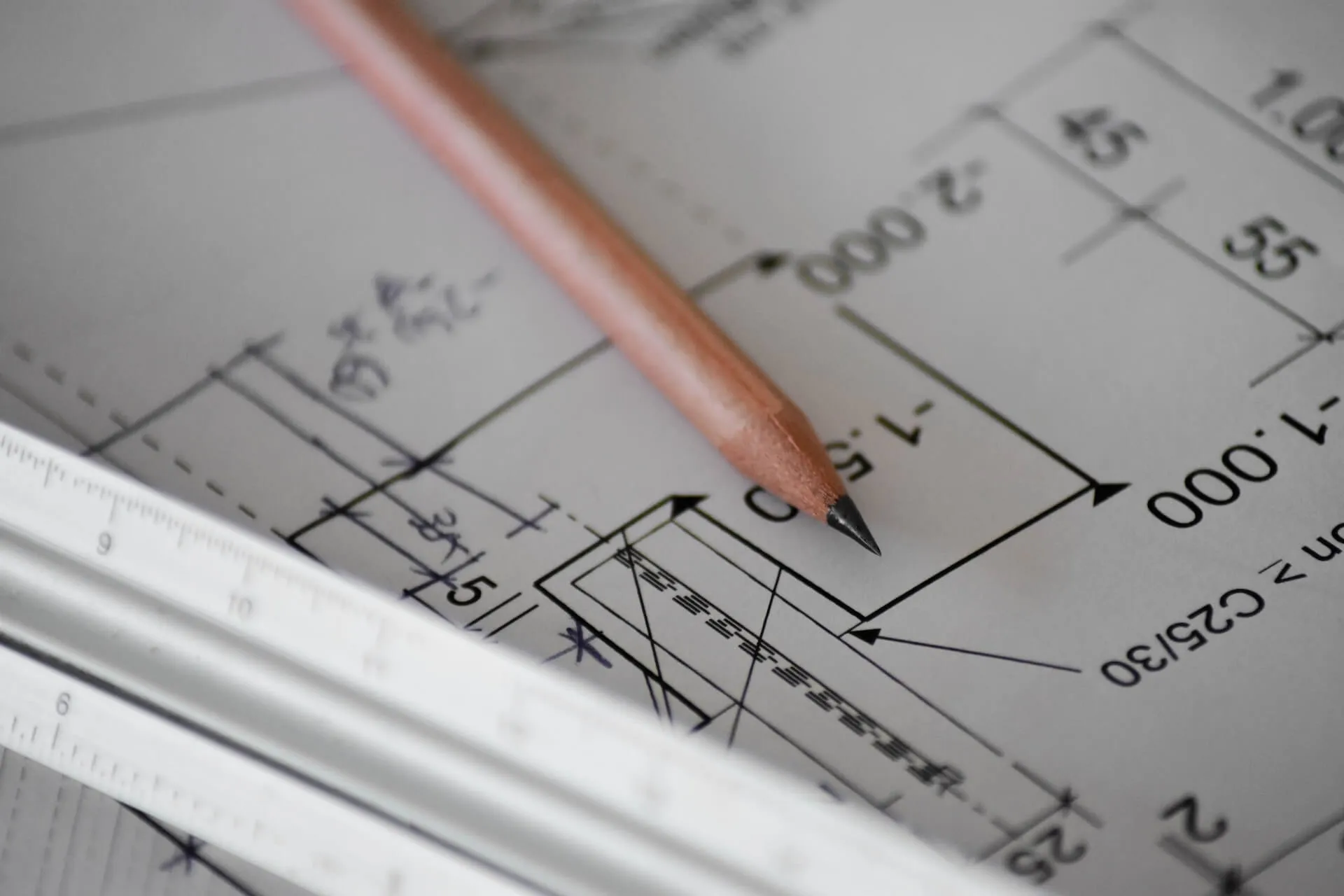 A pencil laying on top of a blueprint