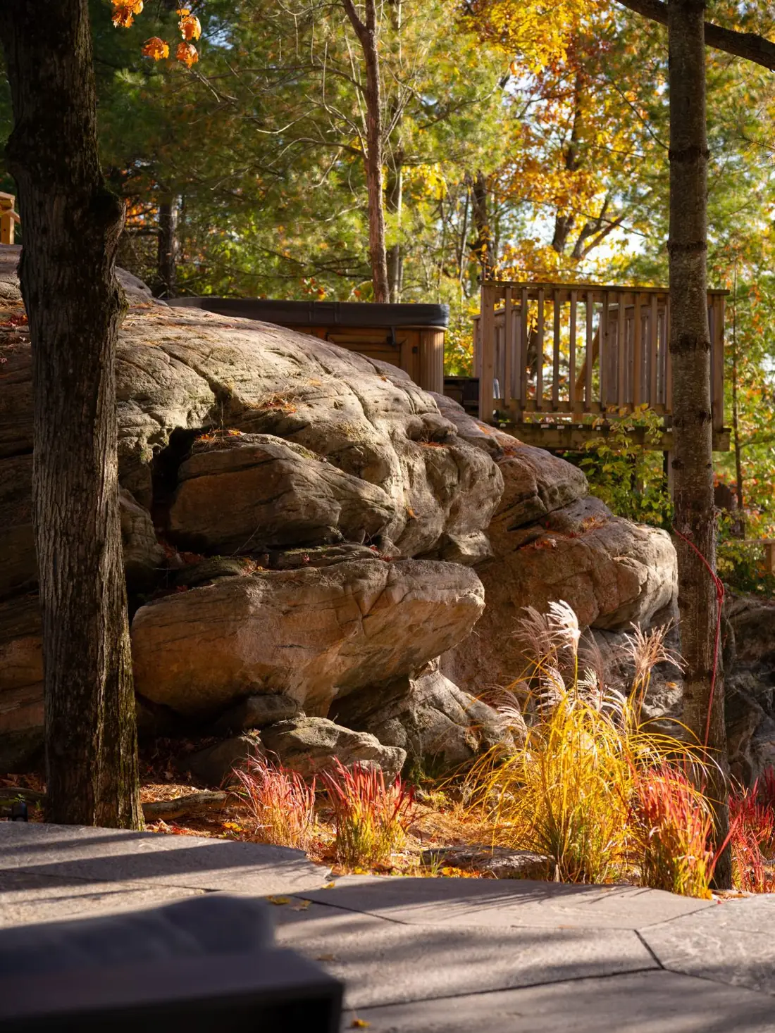 Granite outcrop and natural stone walls in an autumn garden