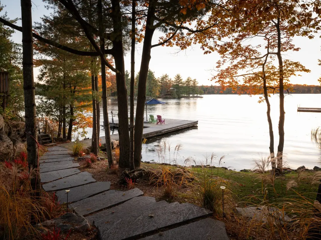 Natural stone slab path leading down to the dock and lake