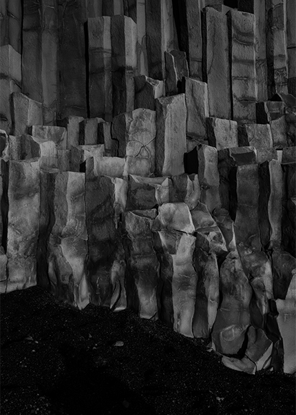 Black and white close-up of basalt column rock formations in Iceland.