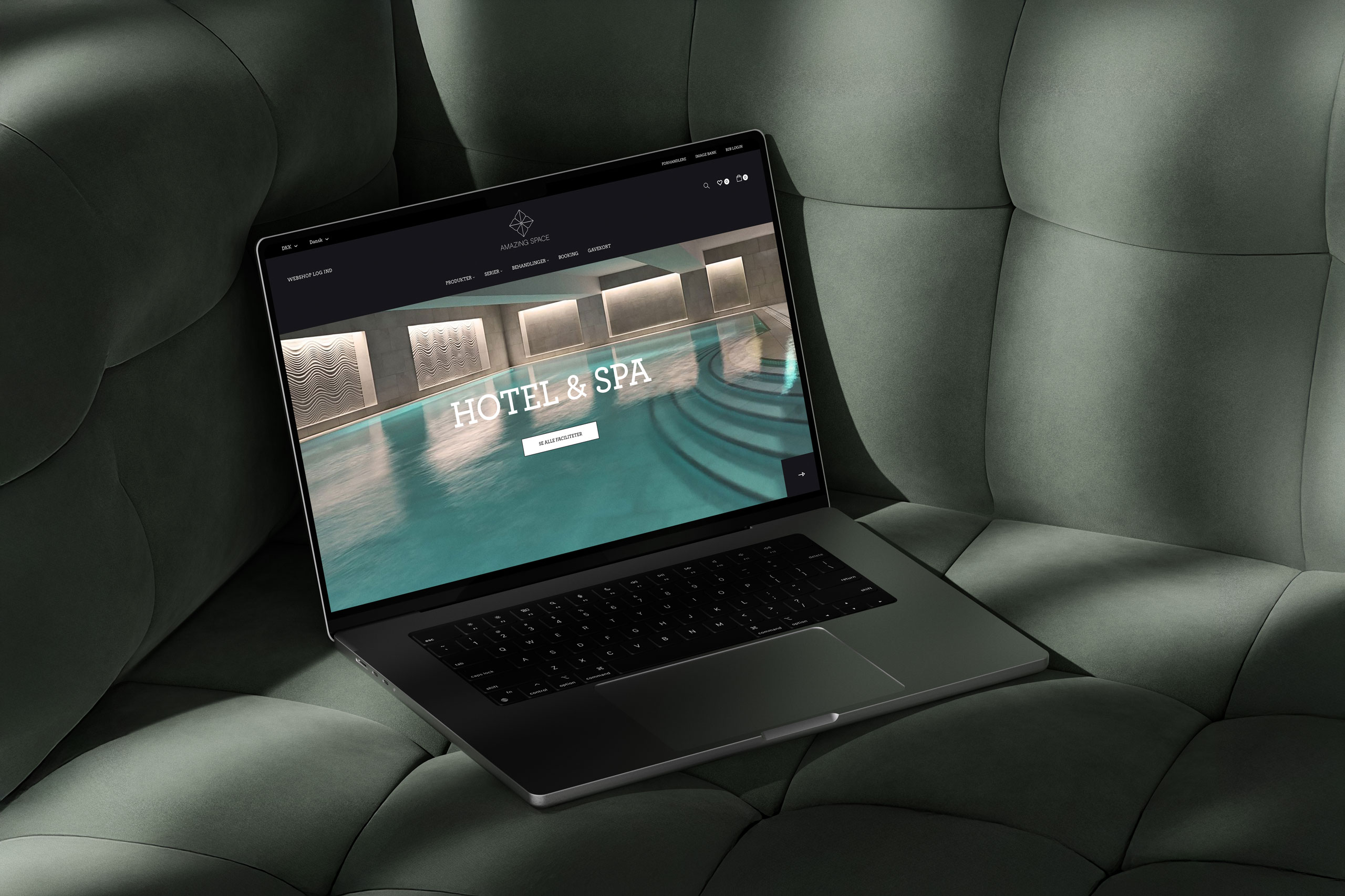 Laptop mockup displaying Amazing Space's website design with a modern indoor pool background.
