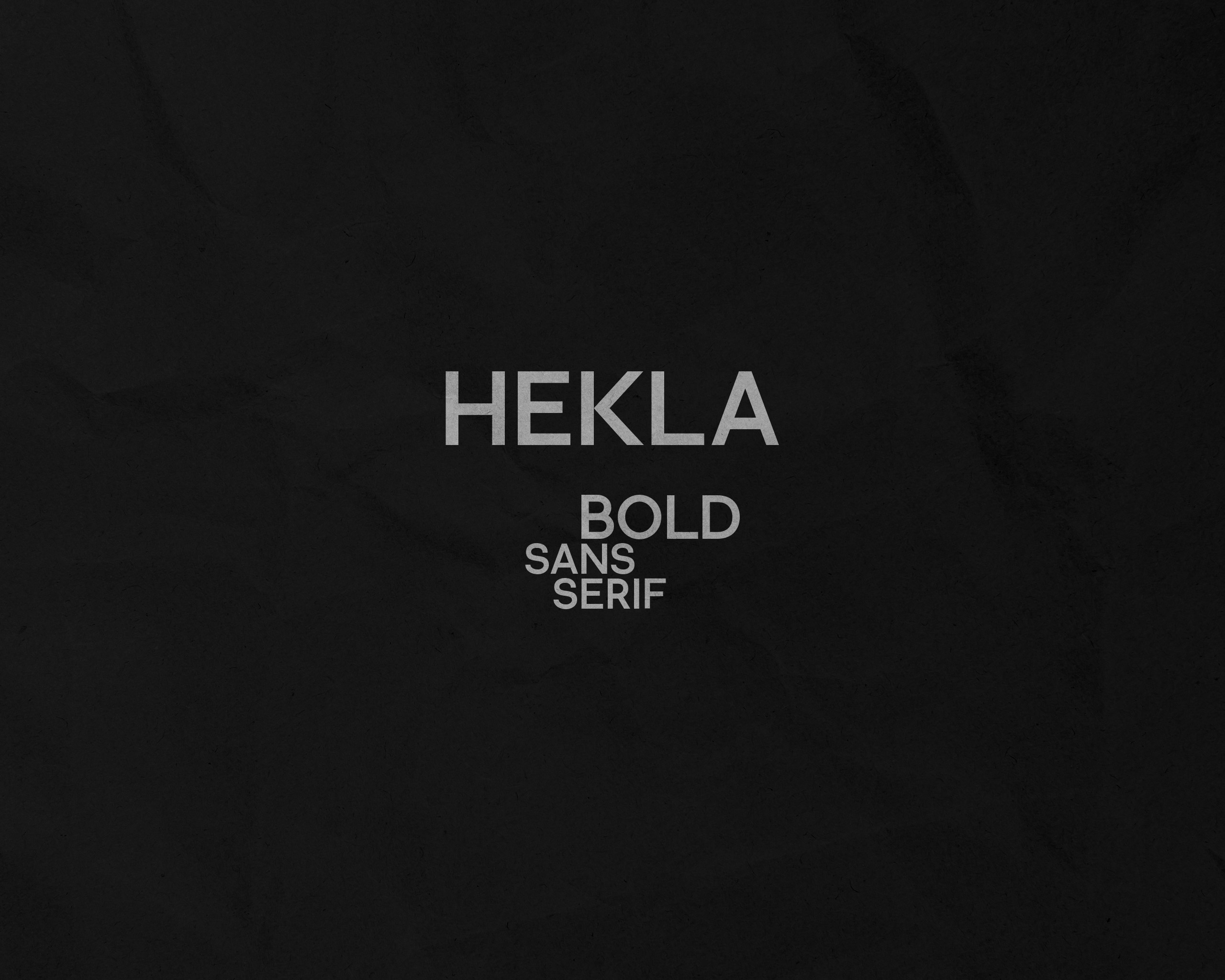 Typography design presentation showing the word ‘HEKLA’ in bold sans-serif font on a black textured background.