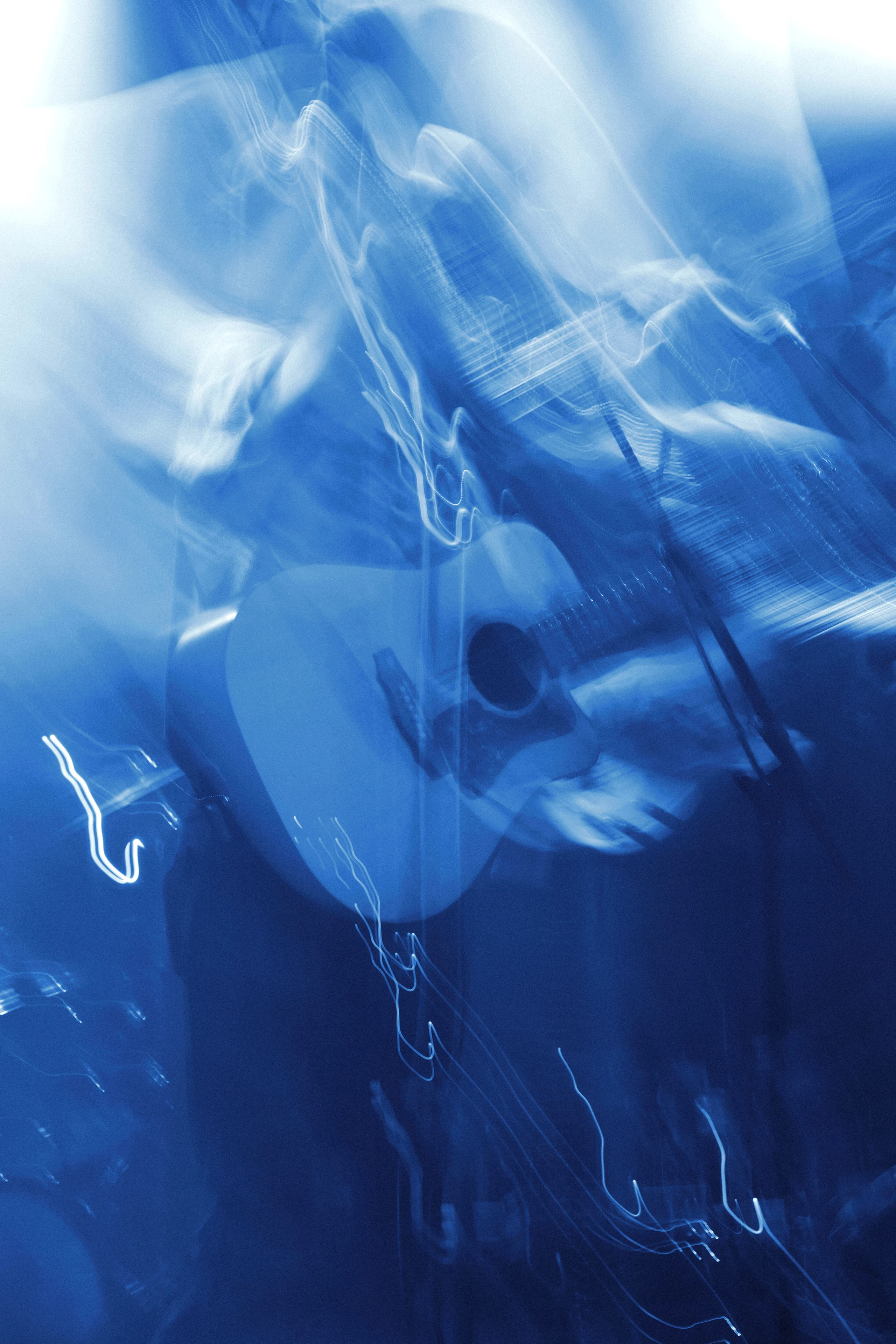 Abstract long-exposure "light painting" of an acoustic guitar during a Thoughtfool set. Captured by photographer Patrick Pankalla.