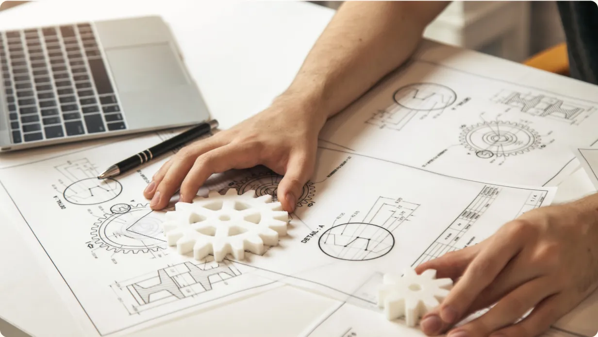 Man sketching and designing mechanical system