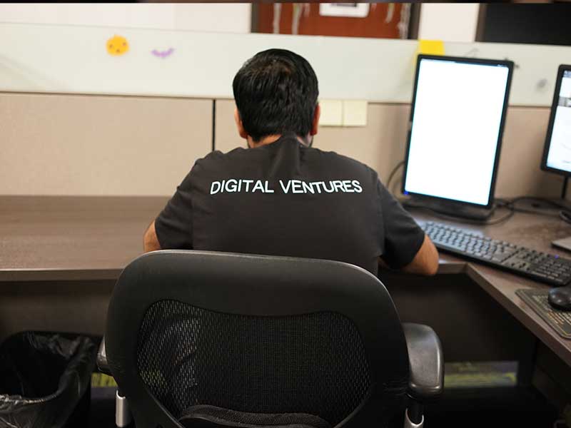 MGM digital ventures developer with his back to the camera writing code on the computer.
