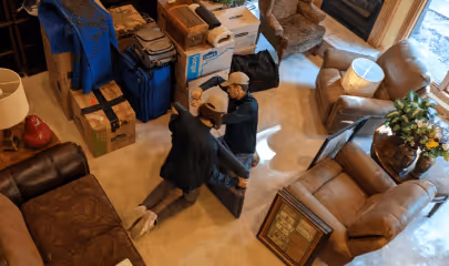 Movers packaging valuable items before transport