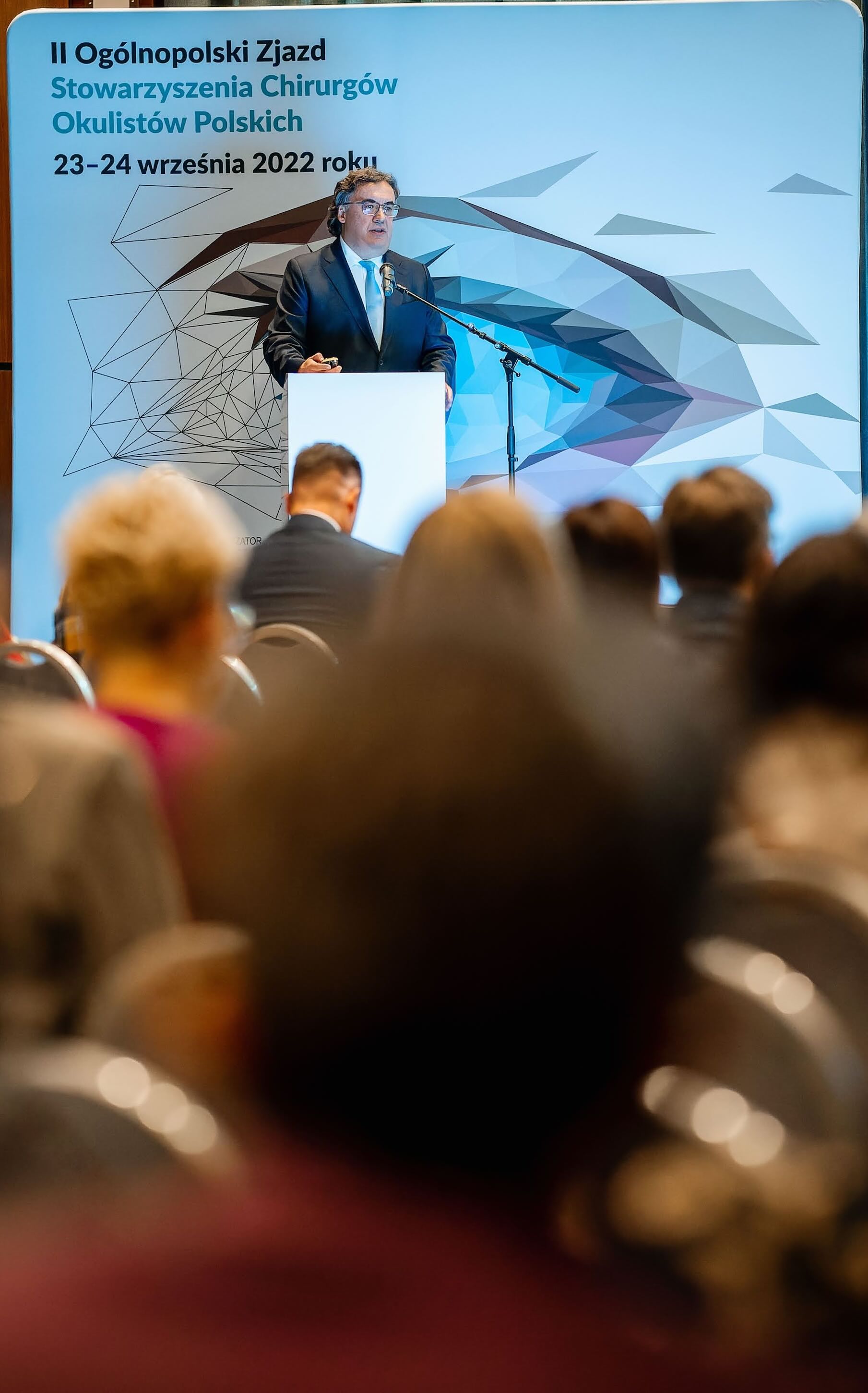 Balcony view of a city: Modern grey architecture against a tranquil white sky blue sunrise