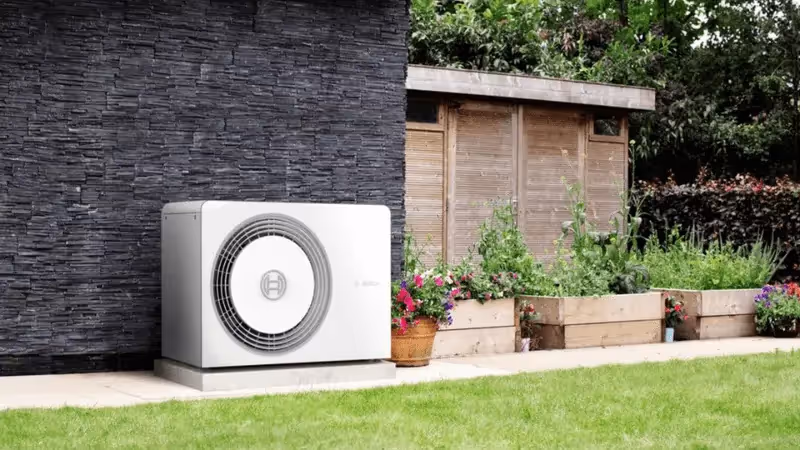 A Worcester Bosch compress 5800 heat pump ousite on a patio with pot plants in the background