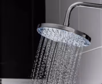 A shower head that is on, with water coming out