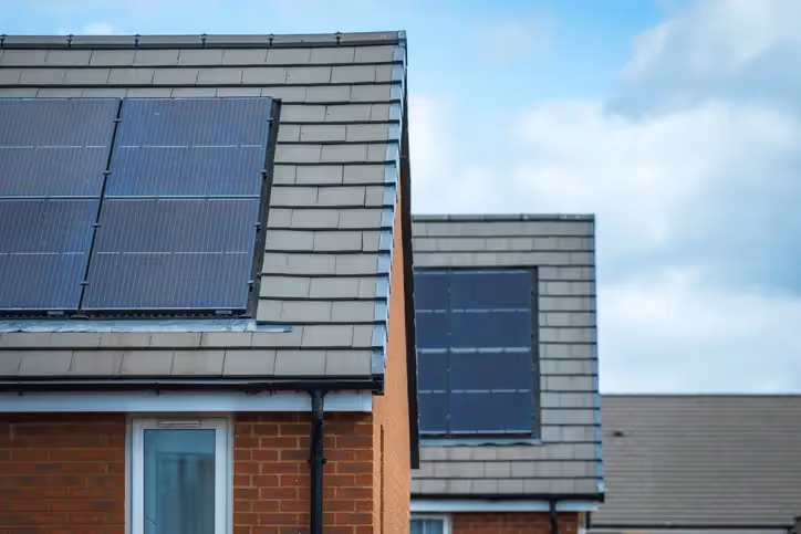 A picture of solar panels on 2 different houses