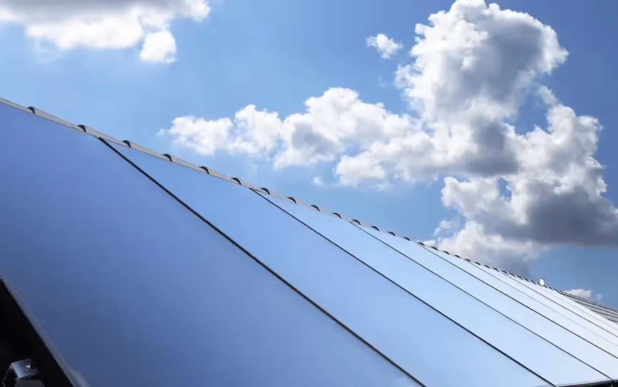 A row of solar panels on a garage roof