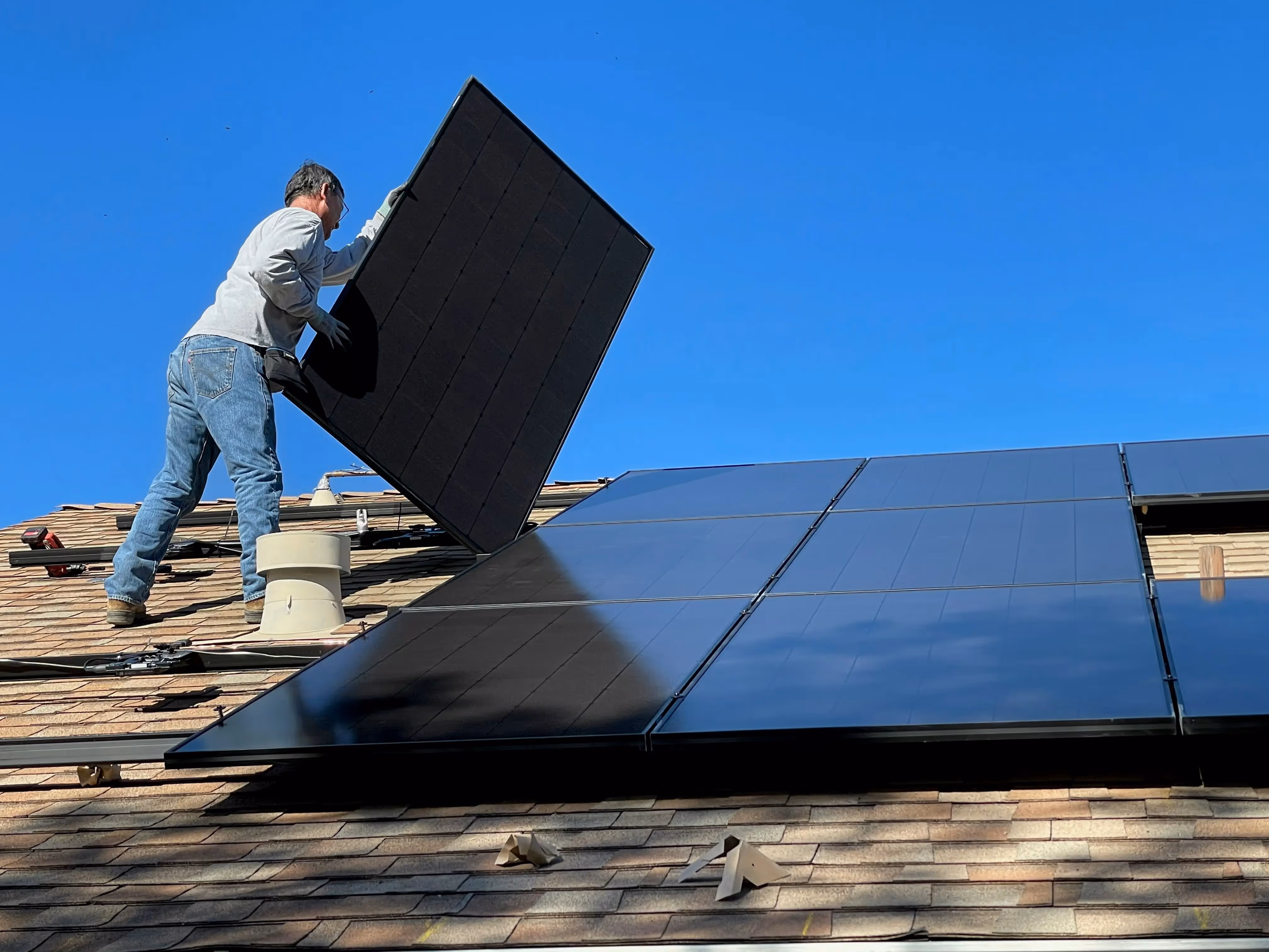 solar panels being installed on a roof