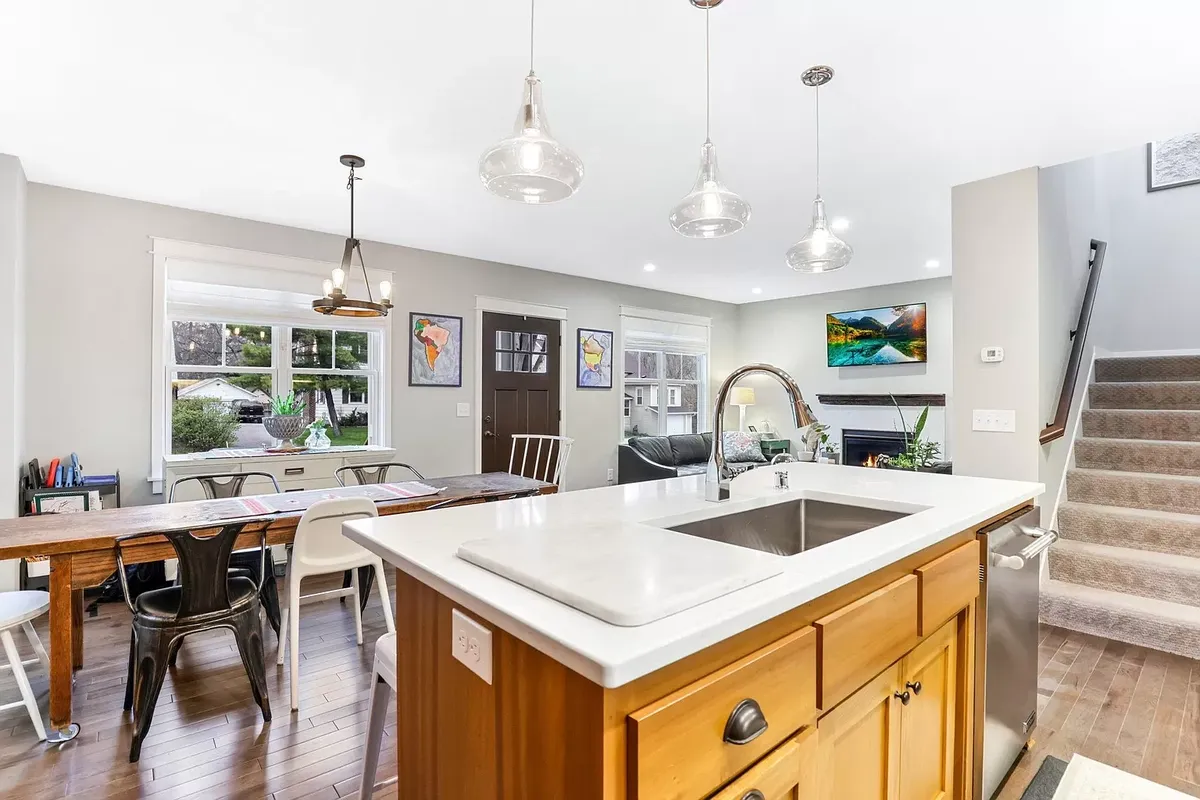 A kitchen with a sink and a stove top oven.