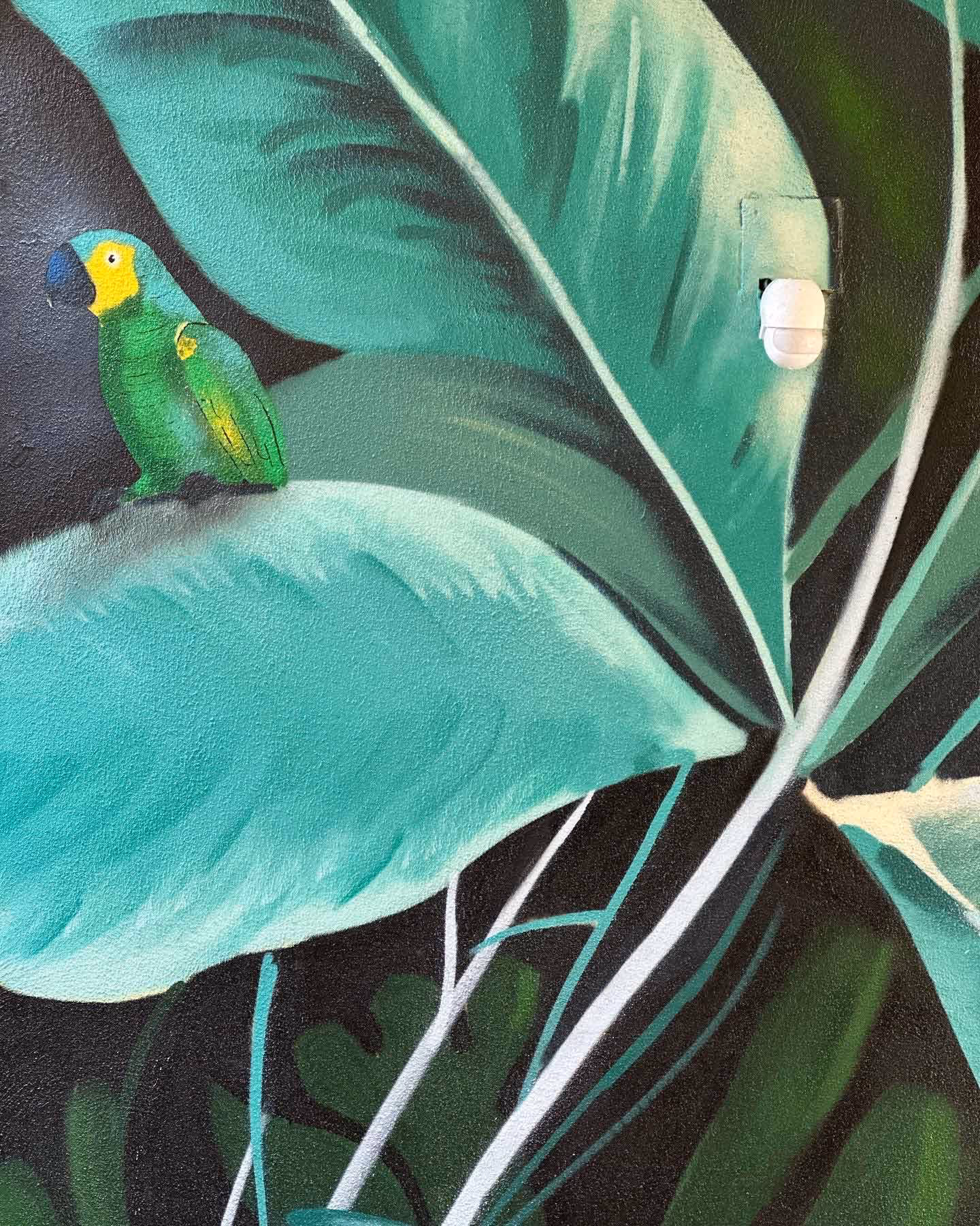 Tropical leaves mural painting with a green parrot
