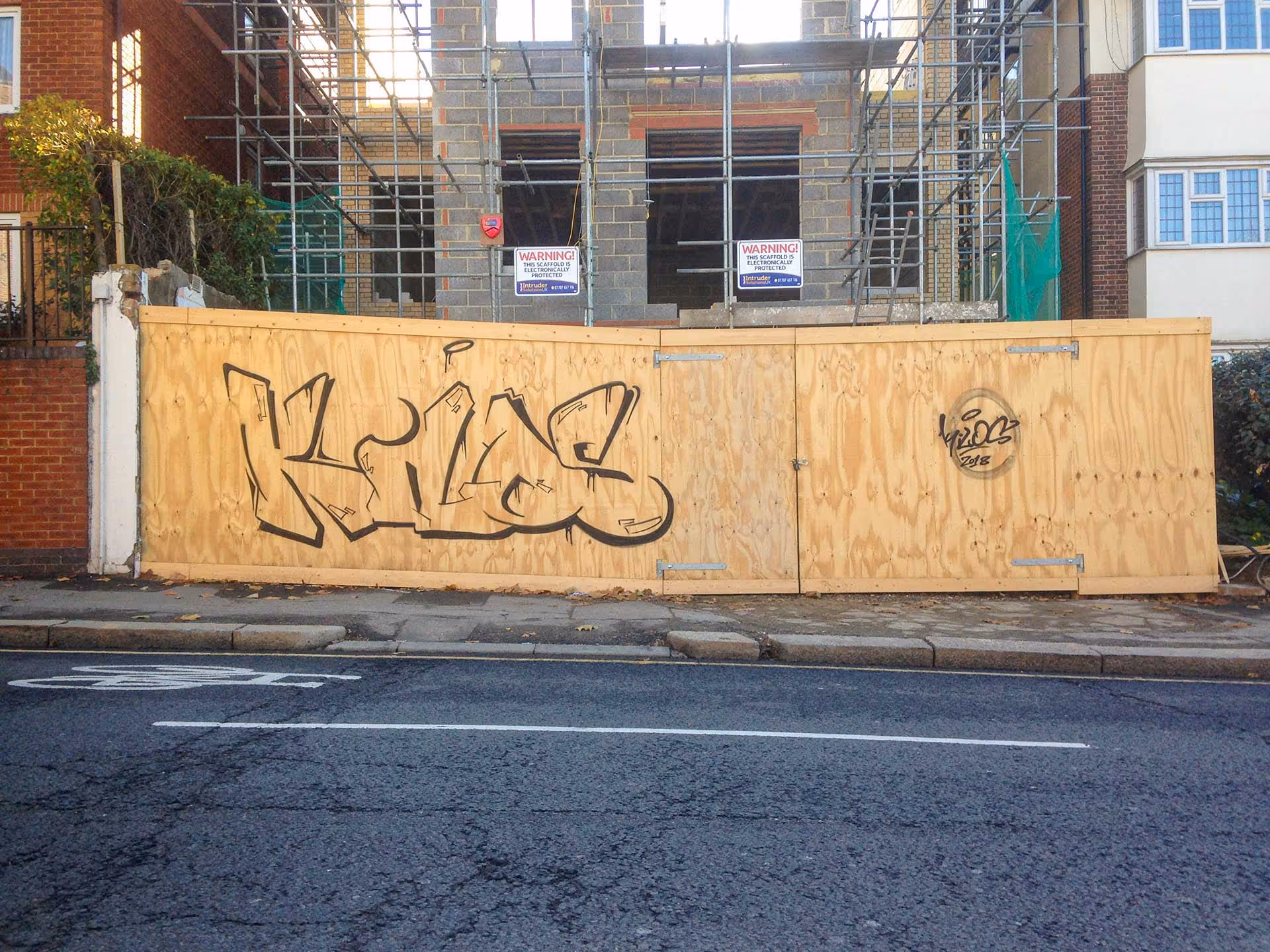 Outline kilos graffiti bombing on wood wall