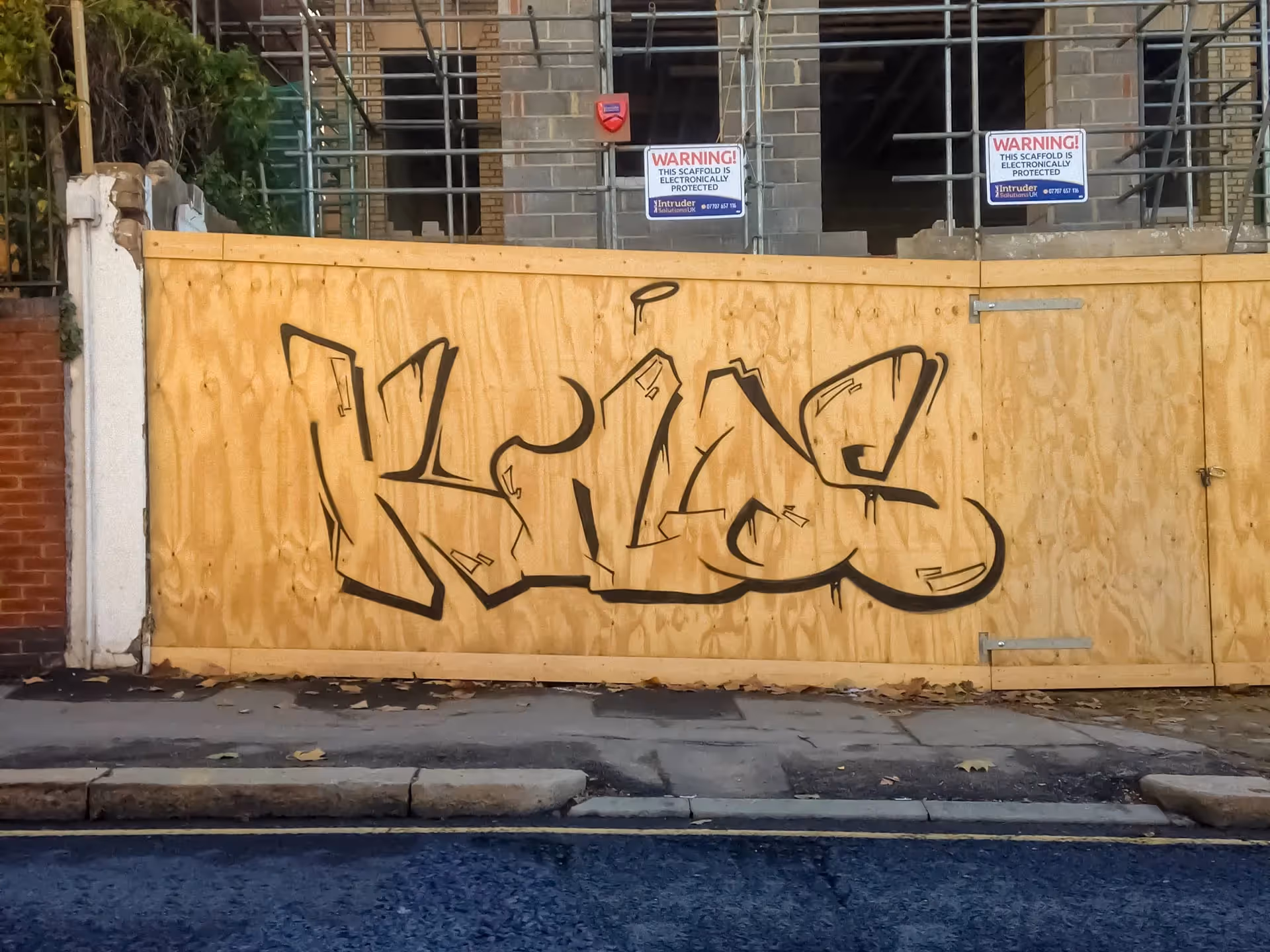 Outline Kilos graffiti bombing on wood wall