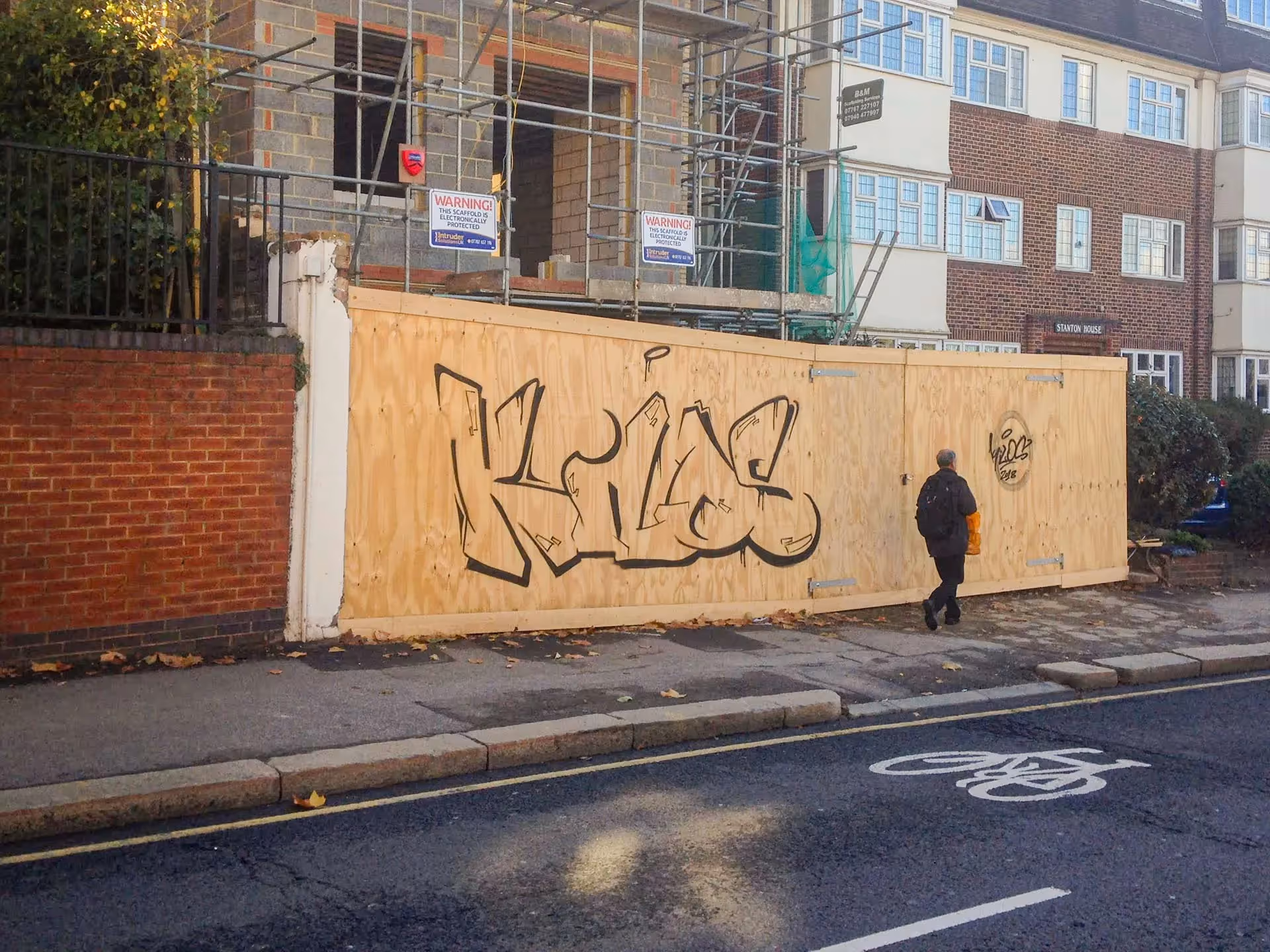 Outline Kilos graffiti bombing on wood wall