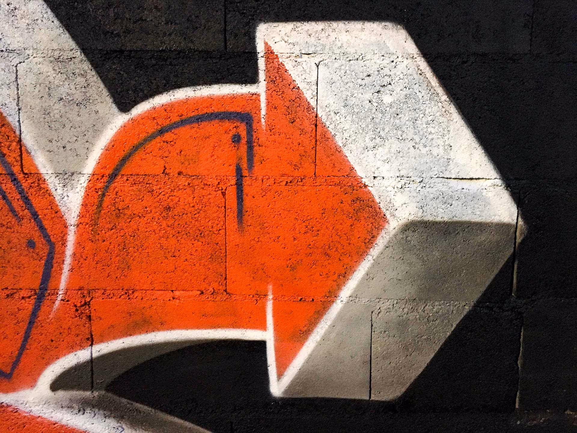 Arrow detail of a blue and orange Kilos graffiti piece