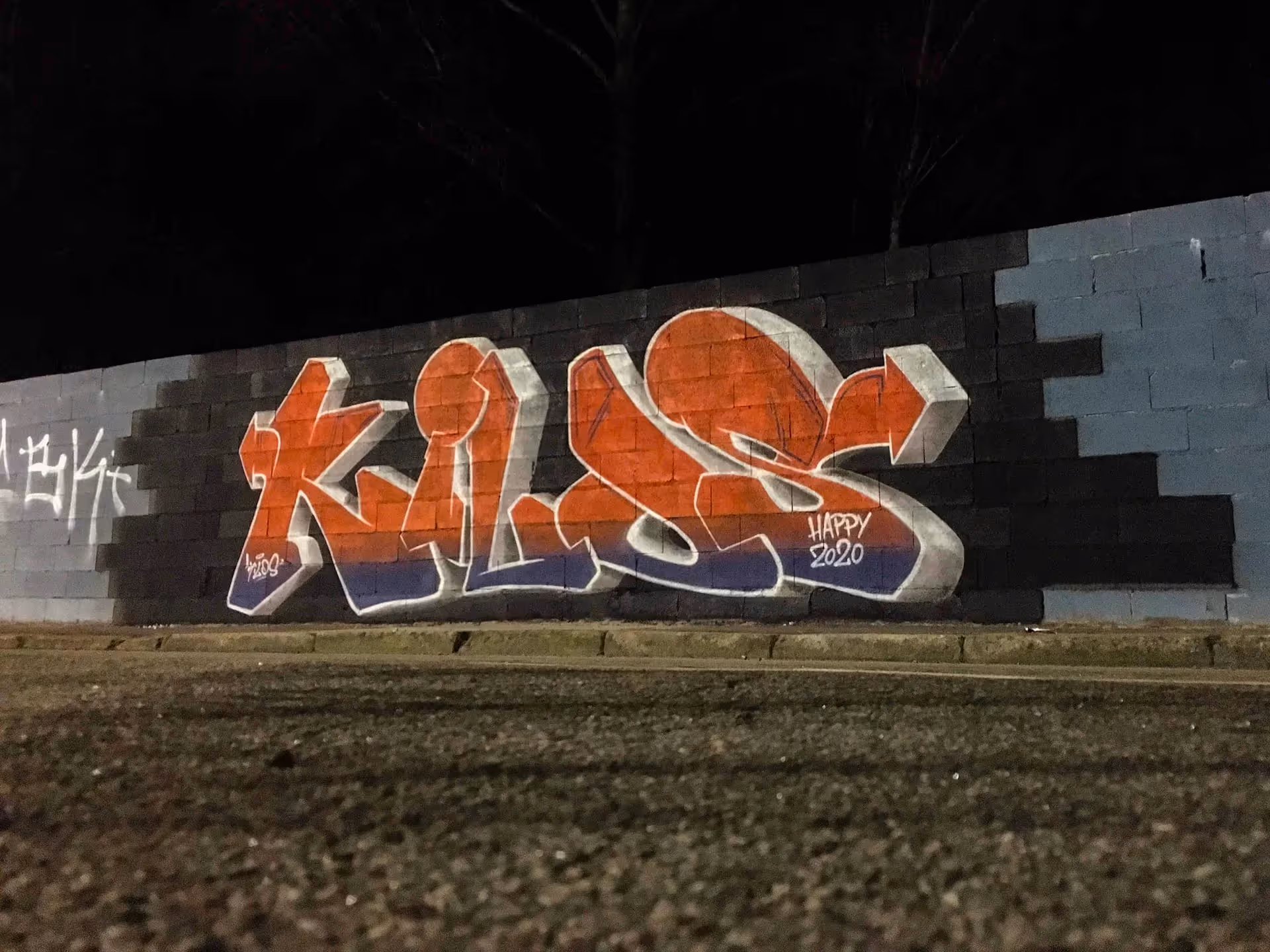 A blue and orange Kilos graffiti piece