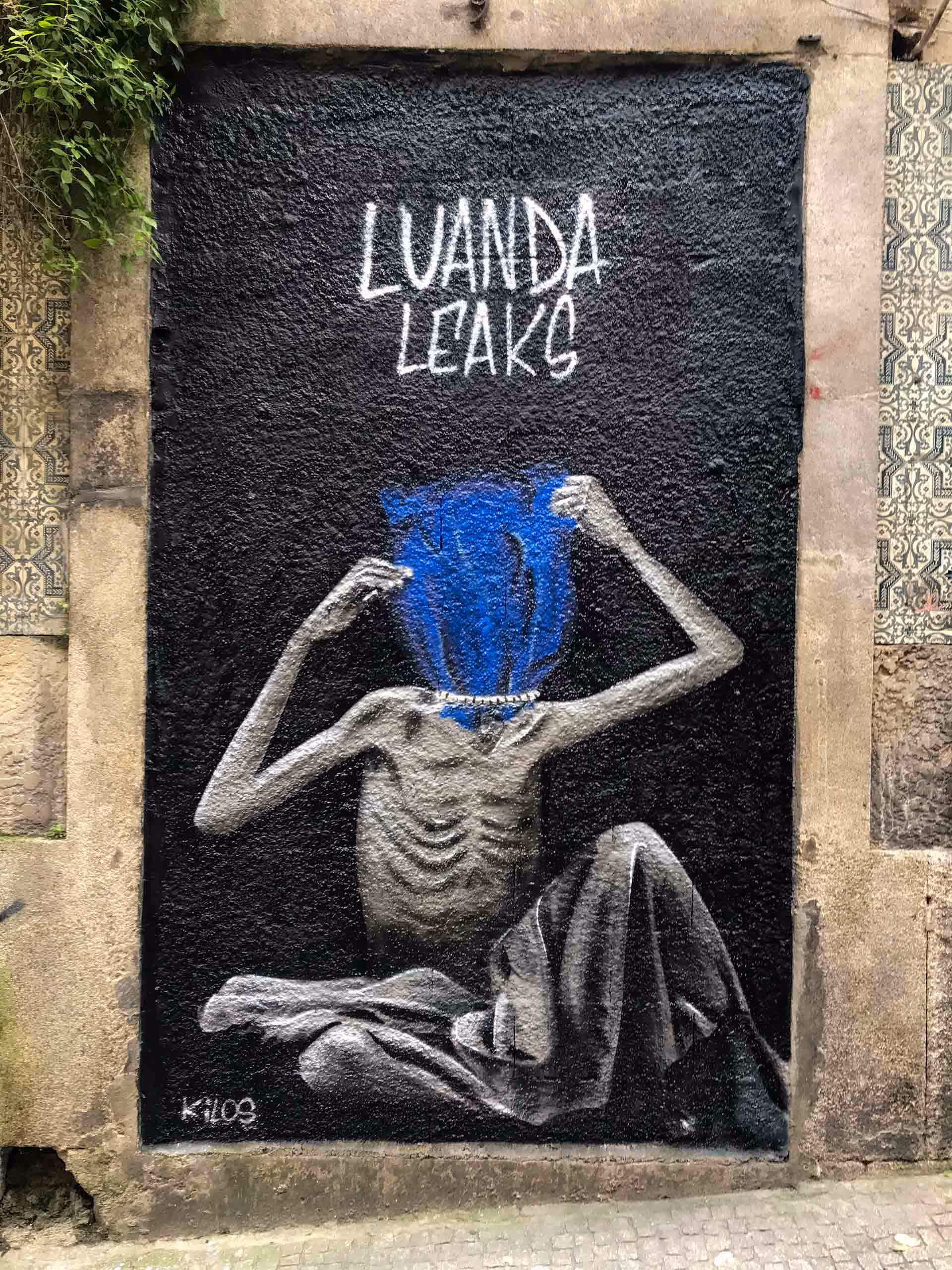 Mural painting of an Angolan child sitting naked trying to get a blue bag off his head that is smothering him with the title - Luanda Leaks