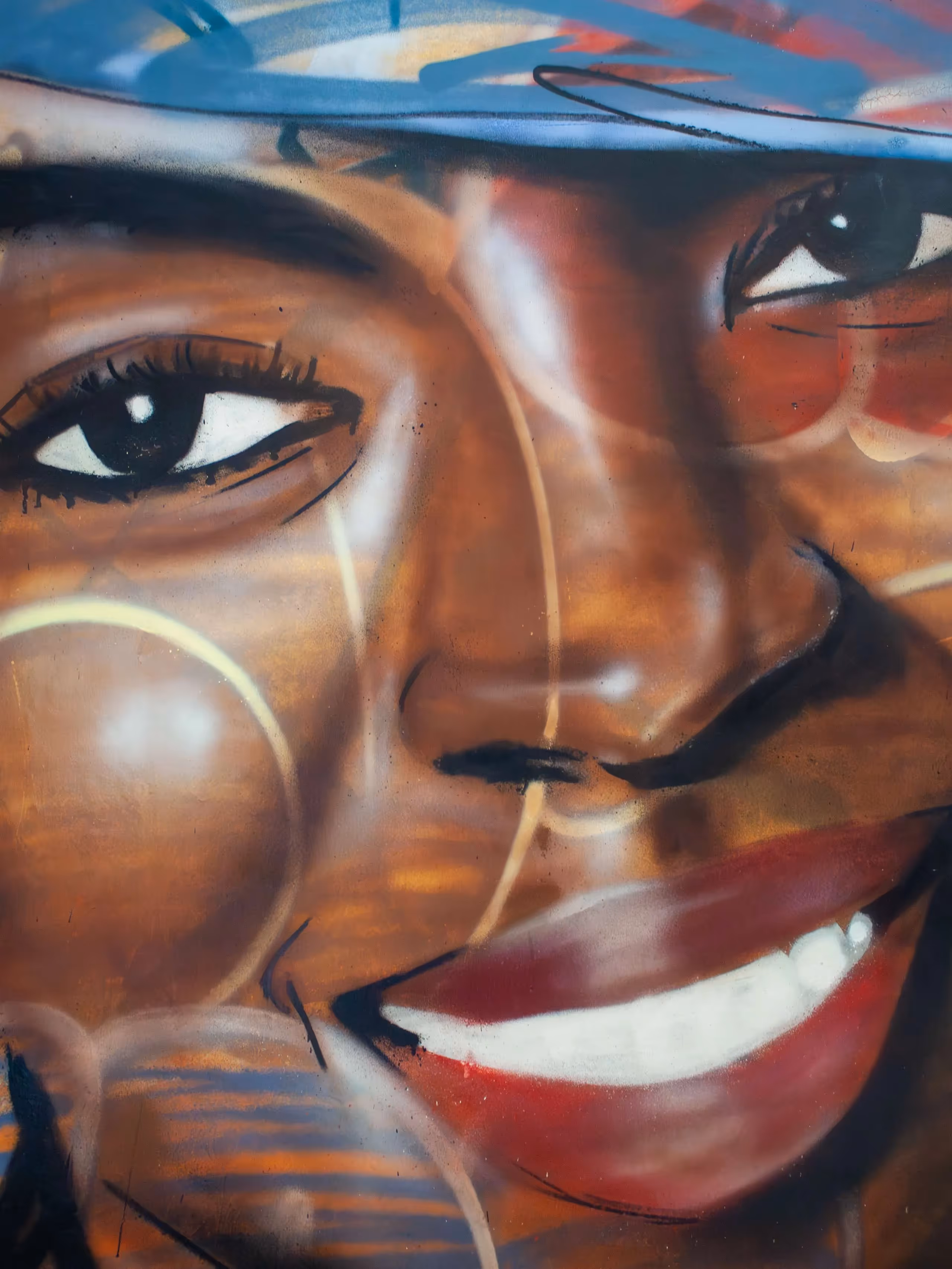 Details of a Lauryn Hill portrait painting on a canvas over a colorful graffiti background