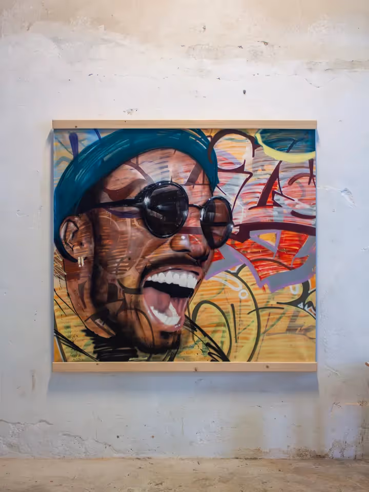 Anderson .Paak portrait painting on a canvas over a colorful graffiti background