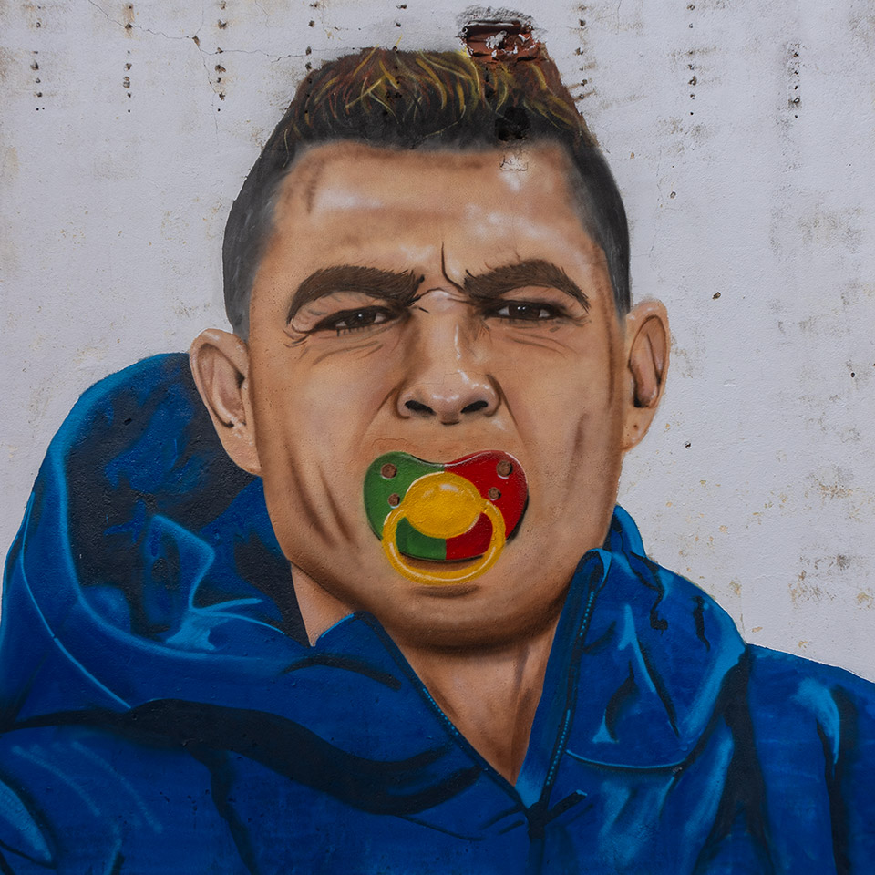 Painting of Cristiano Ronaldo sucking on a pacifier made with Portugal's colors