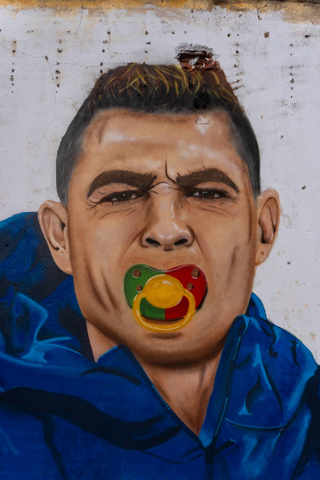 Painting of Cristiano Ronaldo sucking on a pacifier made with Portugal's colors