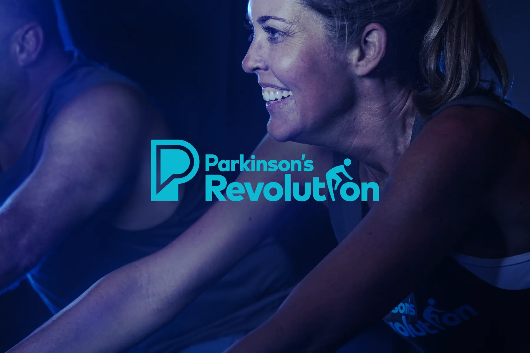 Woman on an indoor bicycle and the Parkinson's Revolution logo.