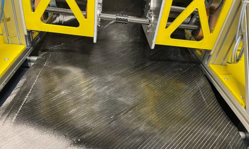 A ±45° tailored non-crimp fabric being produced on the MD25 prototype using Fibraforce Technology with TeXtreme Gapped UD.