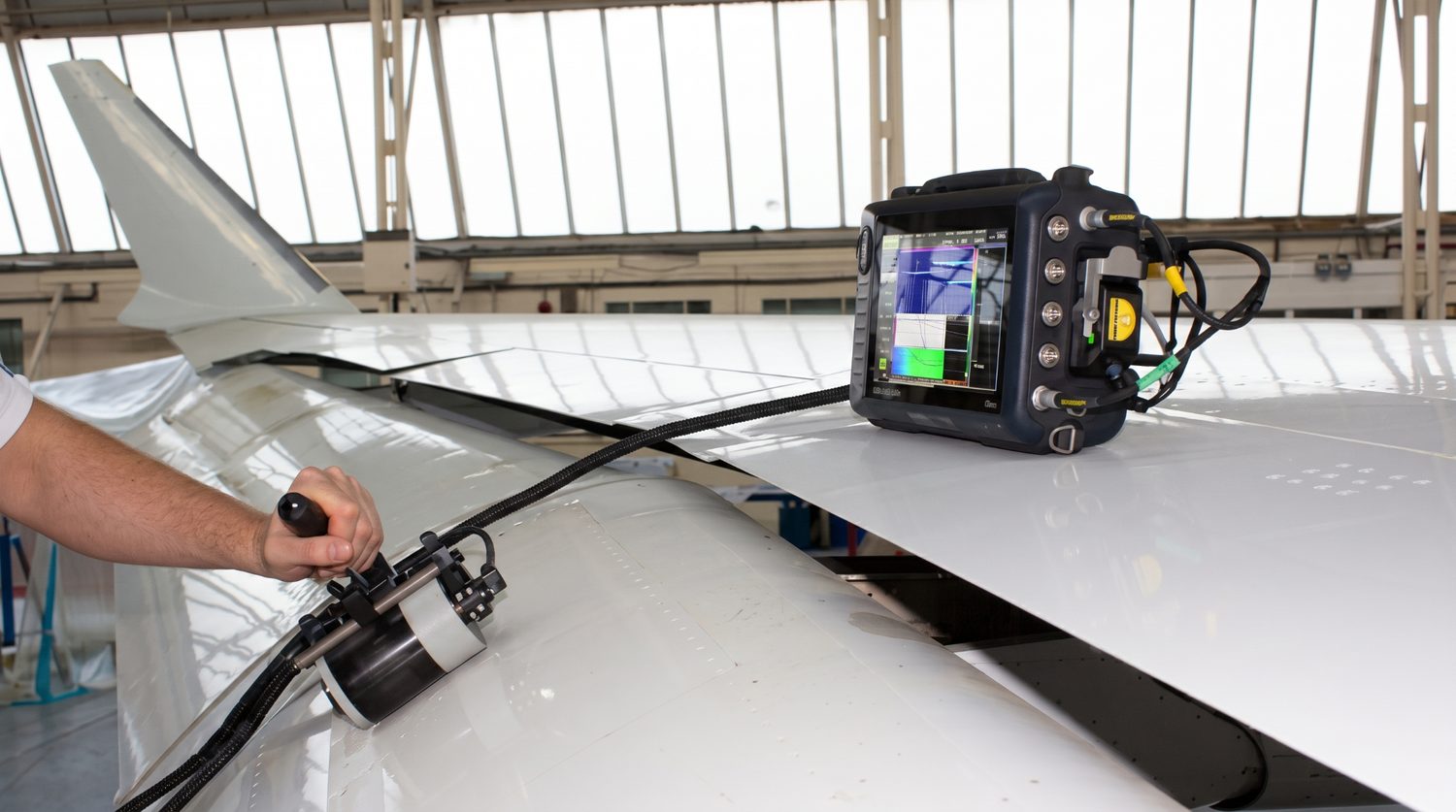 Ultrasonic non-destructive inspection of a composite aircraft structure using a handheld phased-array probe and portable flaw detector, representative of the inspection methods being developed for one-step consolidated parts.