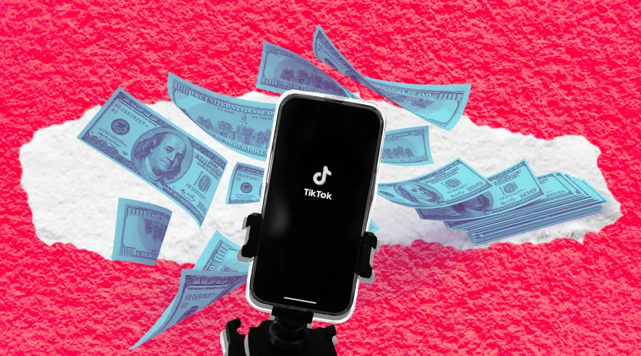 phone on a tripod surrounded by money