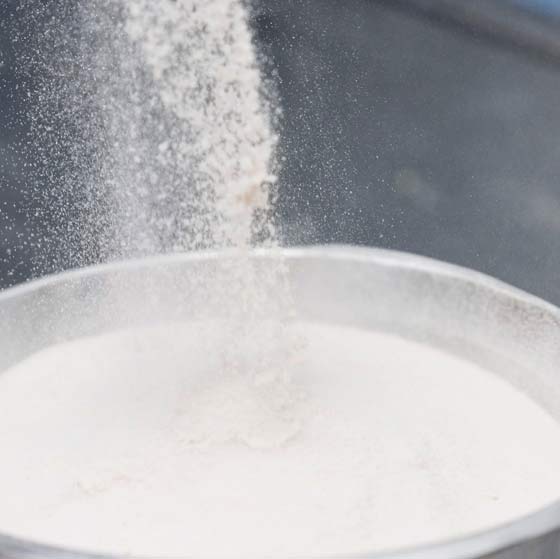 Variety of breaded and fried chicken pieces, including chicken goujons, nuggets, cutlets, and stuffed breasts, served with dipping sauce and cherry tomatoes.