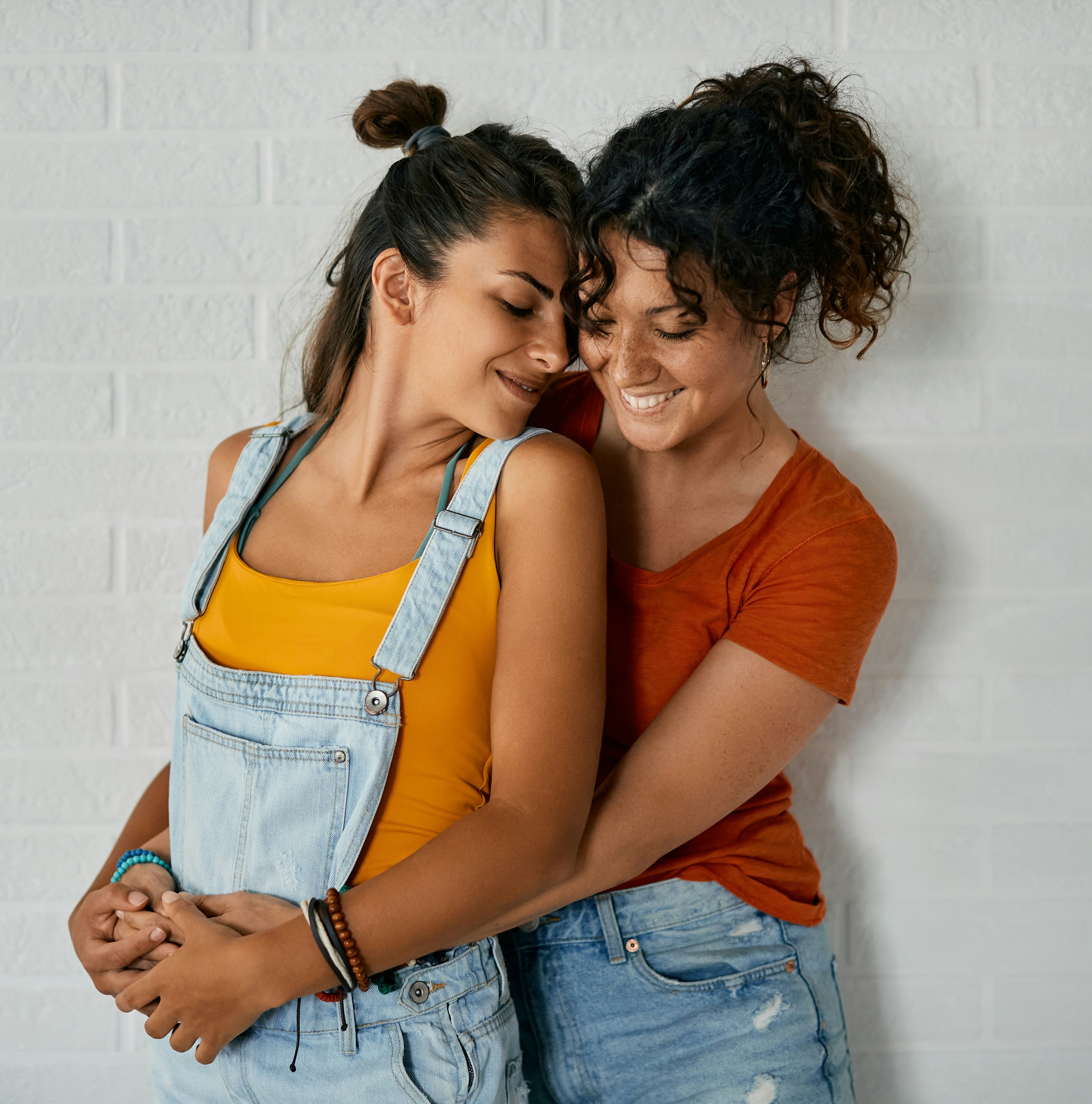 A Black couple embracing while gazing into each others eyes.