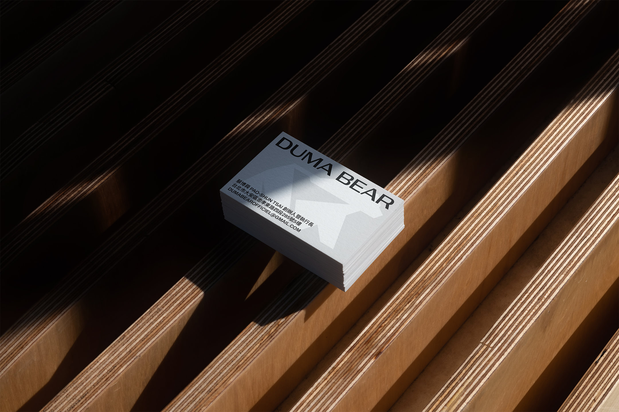 Duma Bear business card on wood plank.
