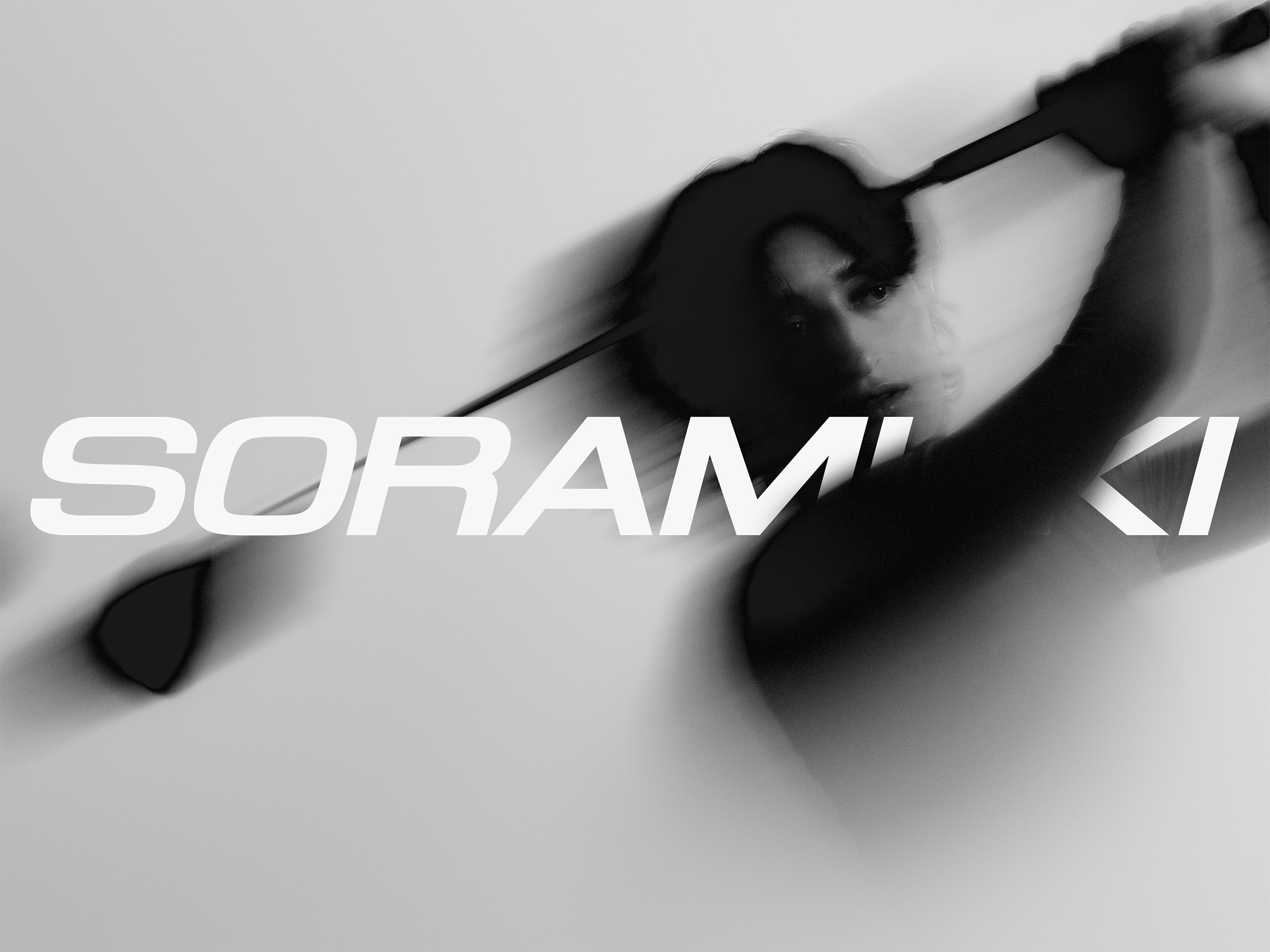 Picture of a woman swinging a golf club with the Soramuki logo crossing her arms.